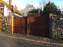 Sapele hardwood gates treated brown hanging on oak posts